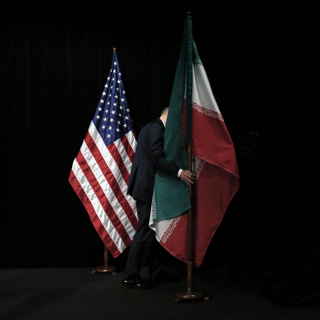 The U.S. and Iranian flags are seen on a stage during nuclear talks in Vienna, Austria. 