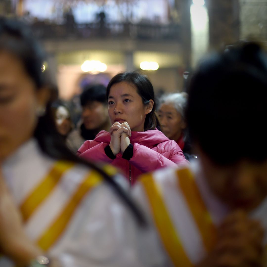 Chinese worshippers attend Christmas Eve Mass at a Catholic church in Beijing during 2015.