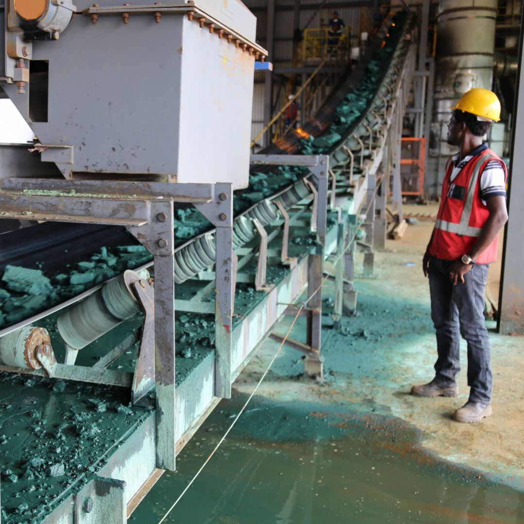 A man supervises a conveyor belt loaded with raw cobalt at a plant in Lubumbashi, Democratic Republic of Congo, on Feb. 16, 2018. 