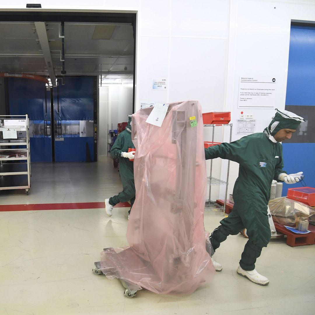 Workers at an ASML factory move parts of a chipmaking machine before shipment in Veldhoven, the Netherlands, in 2018.