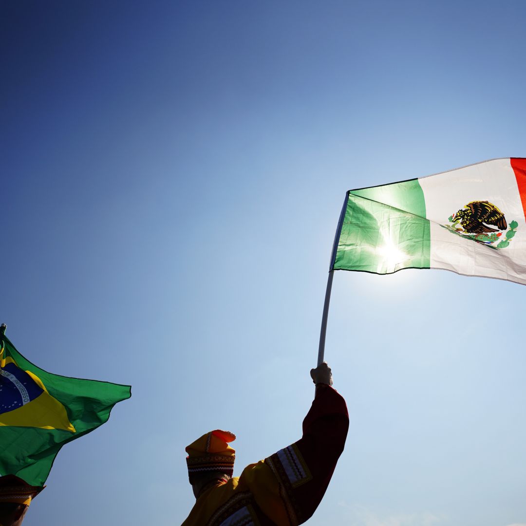Fans hold up Mexico and Brazil's national flags at the 2018 FIFA World Cup. Fans hold up Mexico and Brazil's national flags at the 2018 FIFA World Cup.