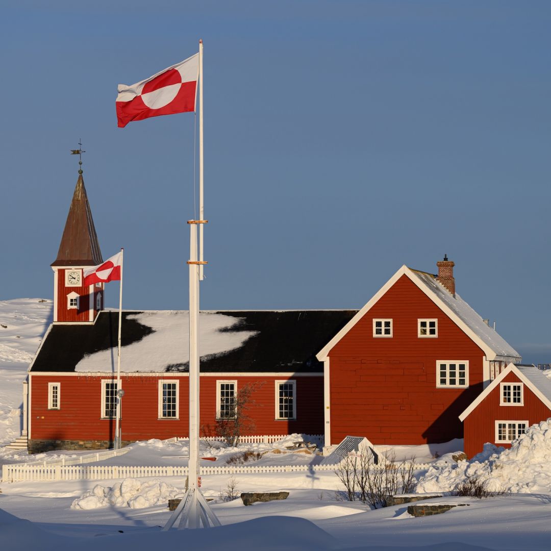 The flag of Greenland, known locally as "Erfalasorput," flies next to the Church of Our Saviour on March 30, 2025, in Nuuk, Greenland. 