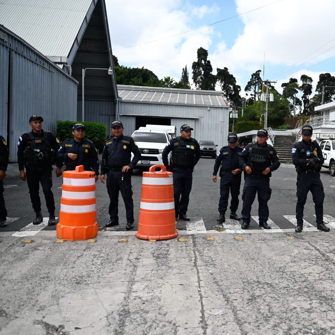 Police officers remain at the entrance of the Electoral Process Operations Center during government raids in Guatemala City on Sept. 12, 2023.