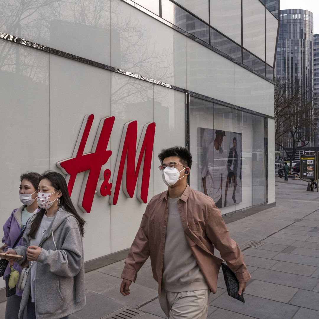 People walk past an H&M store in Beijing, China, on March 25, 2021. 