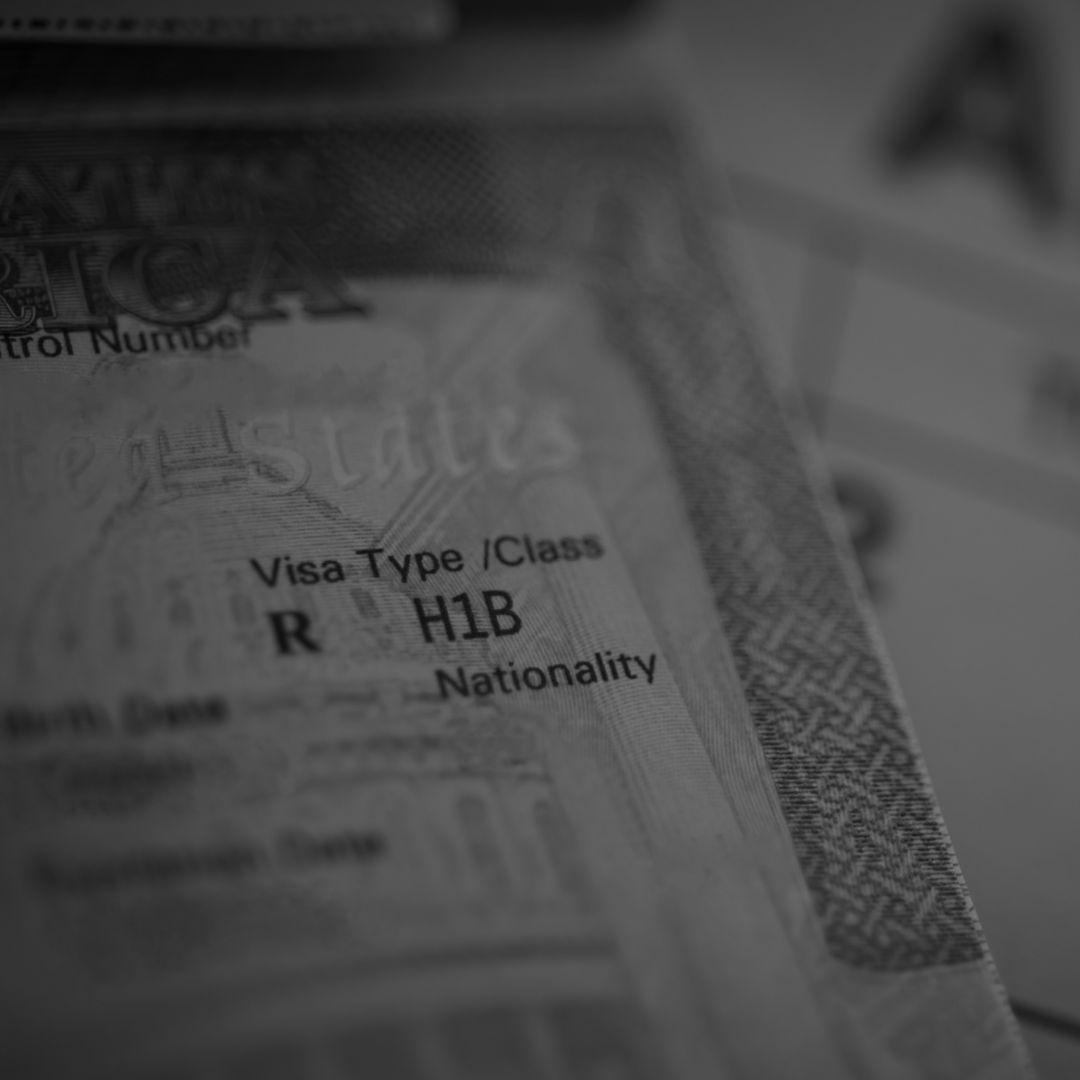 An H1B visa (for specialty workers) stamp is seen in a passport.