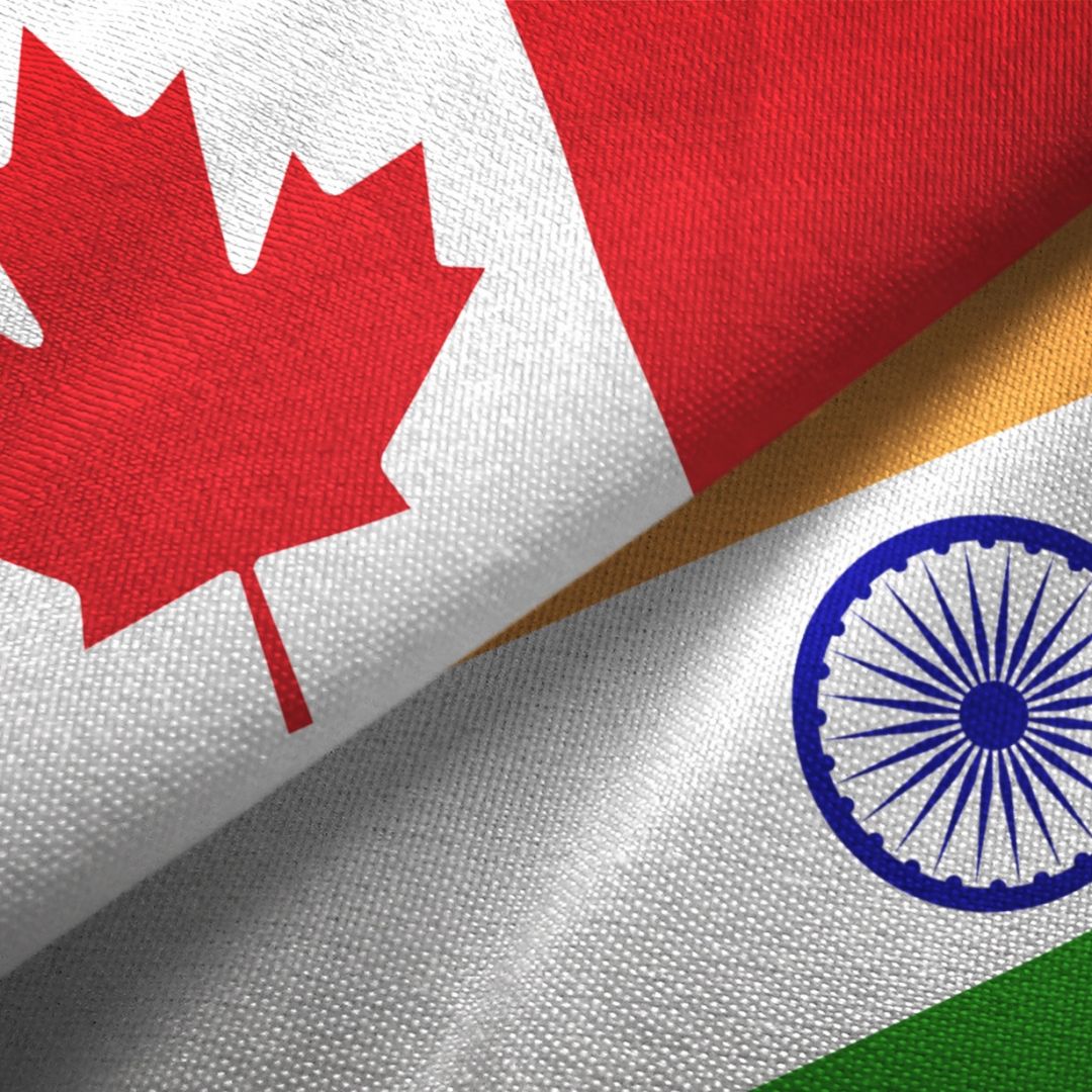 A digital illustration of the Indian and Canadian flags. A digital illustration of the Indian and Canadian flags.