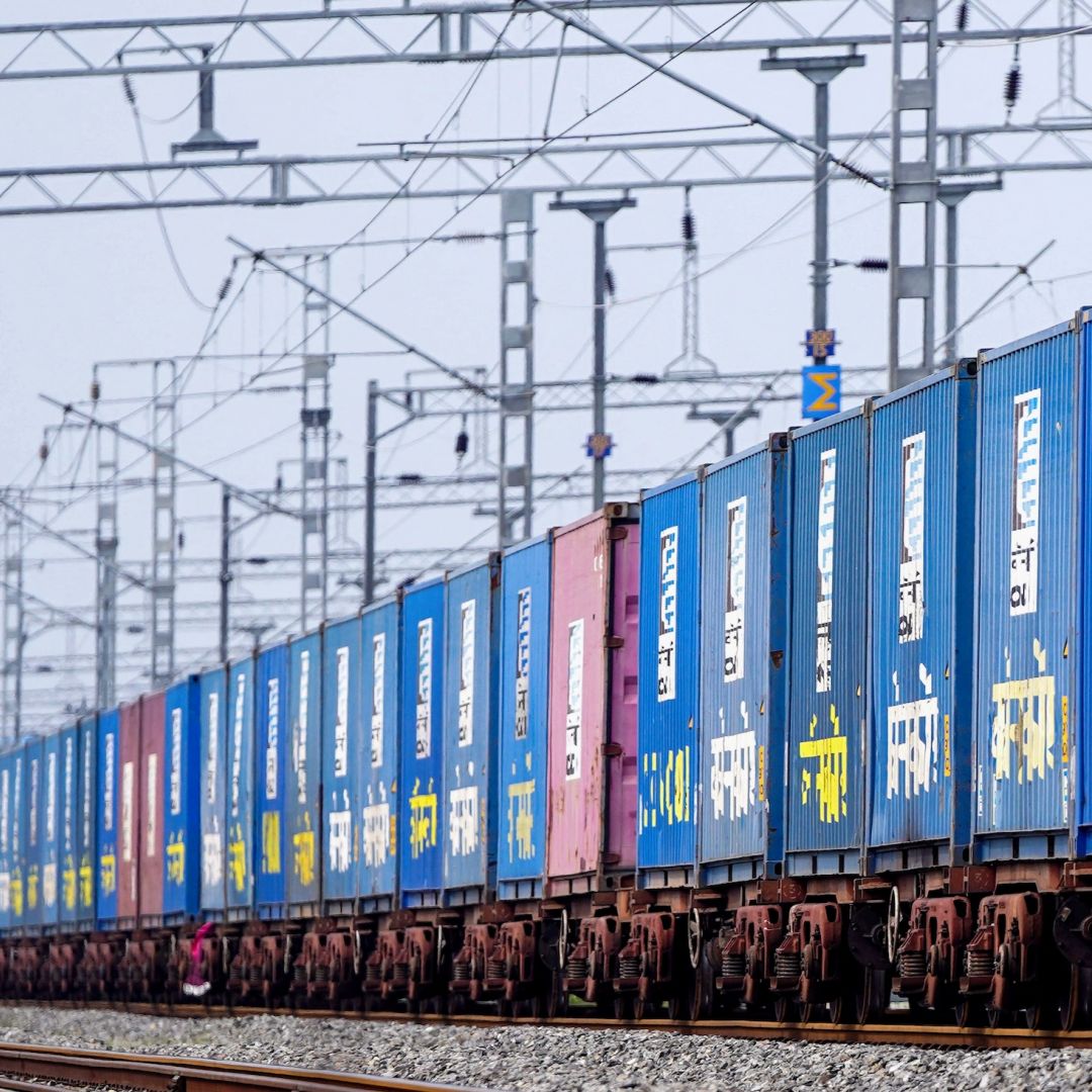 A freight train carrying cargo containers rides along a railway track in Ajmer, India, on Aug. 26, 2025.