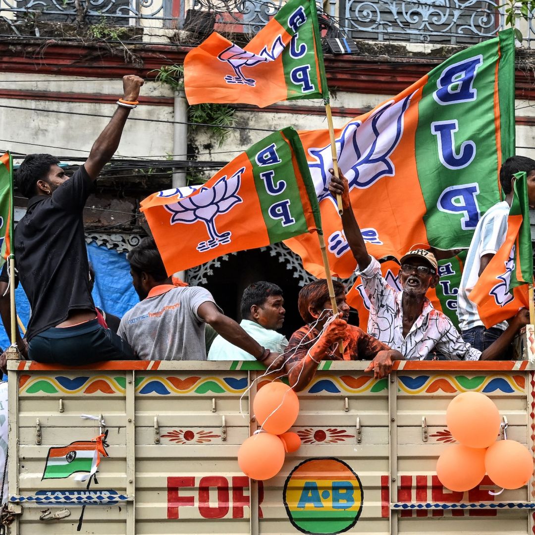 Supporters of the Bharatiya Janata Party (BJP) celebrate with the party flags in Kolkata, India, following state elections in West Bengal.