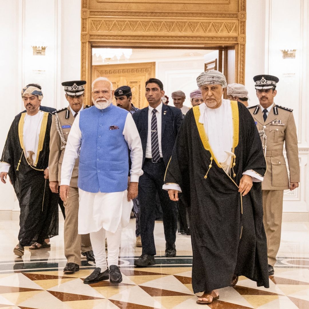Indian Prime Minister Narendra Modi walks alongside Oman's Deputy Prime Minister for Defence Affairs Sayyid Shihab bin Tariq al-Said upon his arrival in Muscat on Dec. 17, 2025.