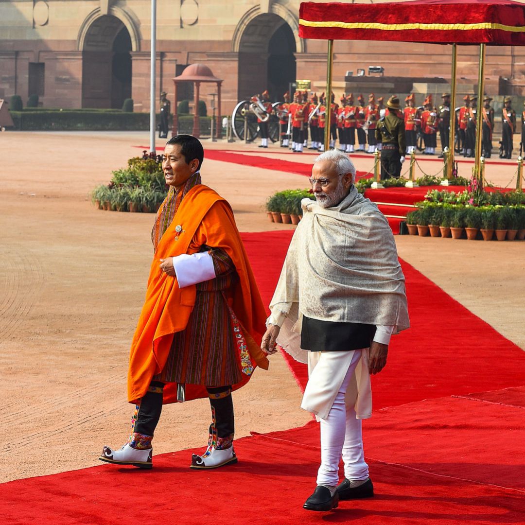 Indian Prime Minister Narendra Modi (R) walks with Bhutanese Prime Minister Lotay Tshering during a ceremonial reception at the Presidential Palace in New Delhi on Dec. 28, 2018.