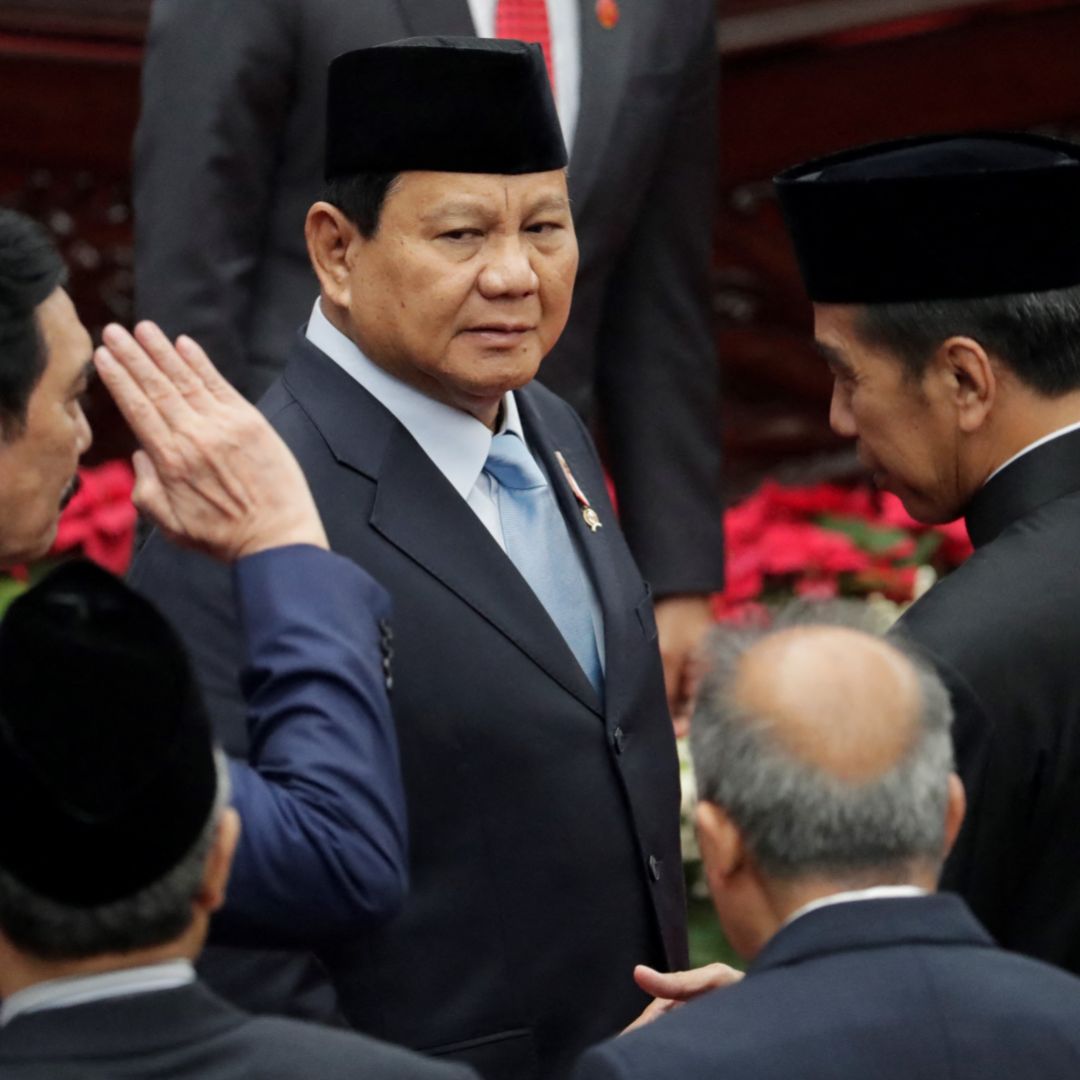 Indonesian Defense Minister and President-elect Prabowo Subianto (center) is seen next to outgoing President Joko Widodo (right) in the parliament building in Jakarta on Aug. 16, 2024. 