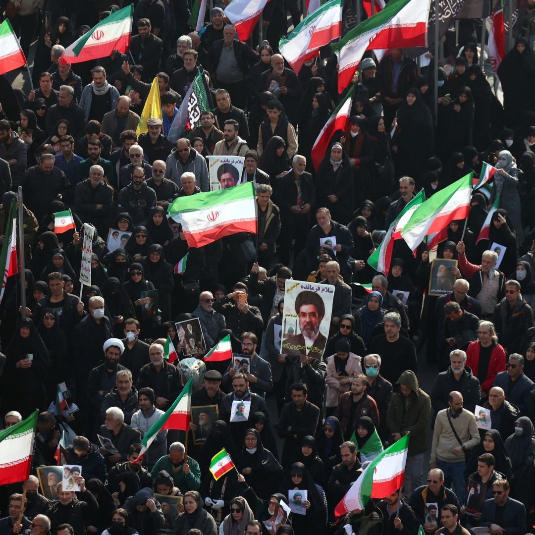 Demonstrators wave Iranian national flags and hold pictures of the country's new supreme leader, Mojtaba Khamenei, at Enghelab Square in central Tehran on March 9, 2026.