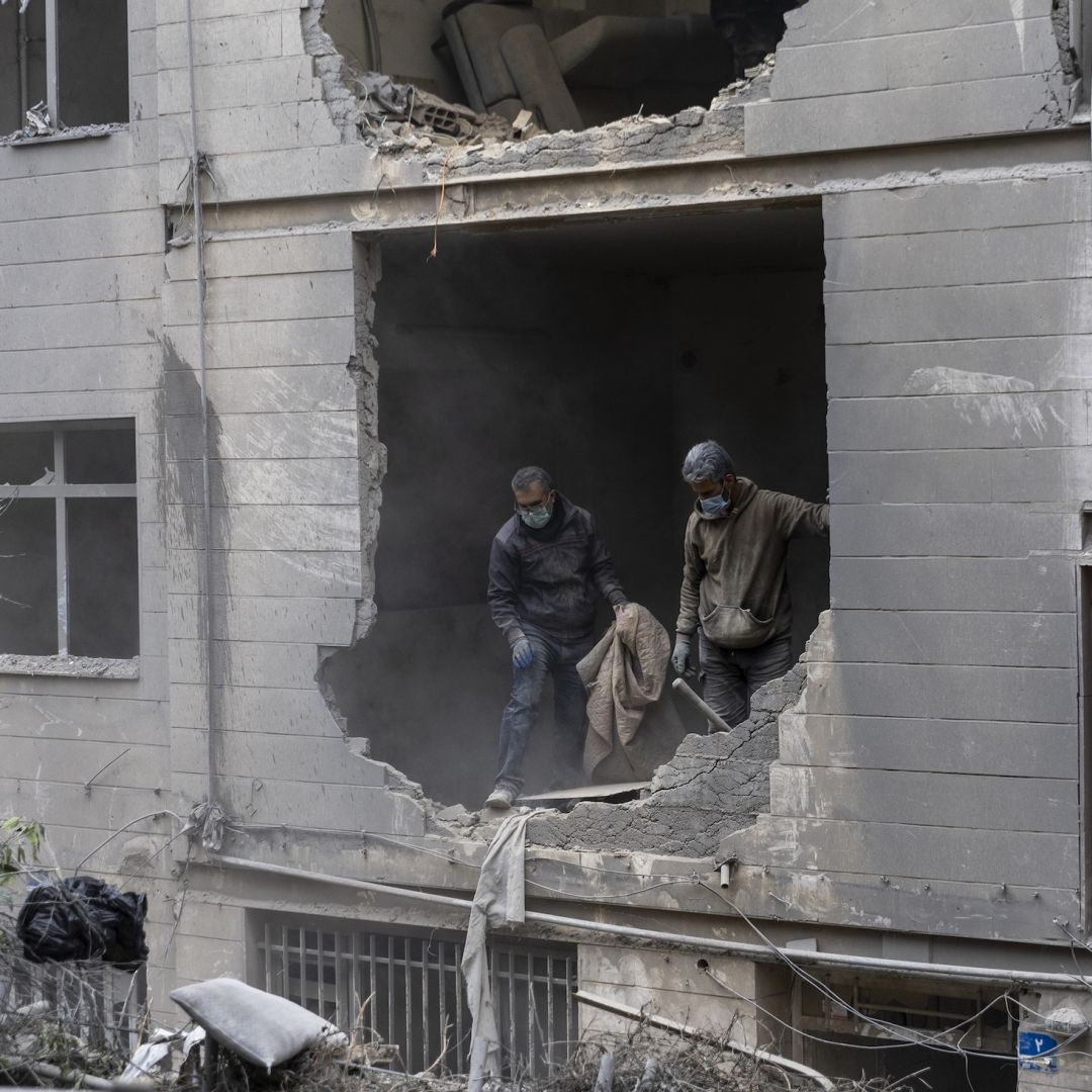People on March 15 in Tehran, Iran, clean up rubble from a missile attack. The Iran war will almost certainly continue through the next week amid Israeli threats to escalate and expand strikes due to Iranian attacks targeting Israeli civilians and the U.S. deployment of additional military assets to the region. People on March 15 in Tehran, Iran, clean up rubble from a missile attack.