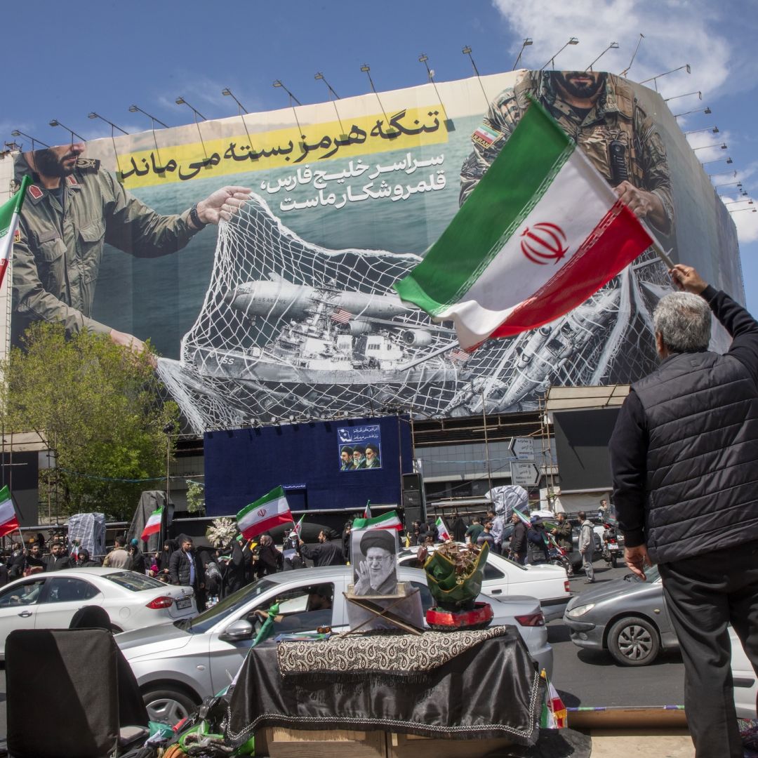 Iranians hold national flags as they gather in Tehran's Revolution Square after the United States and Iran agreed to a two-week ceasefire, on April 8, 2026 in Tehran, Iran. Iranians hold national flags as they gather in Tehran's Revolution Square after the United States and Iran agreed to a two-week ceasefire, on April 8, 2026 in Tehran, Iran.