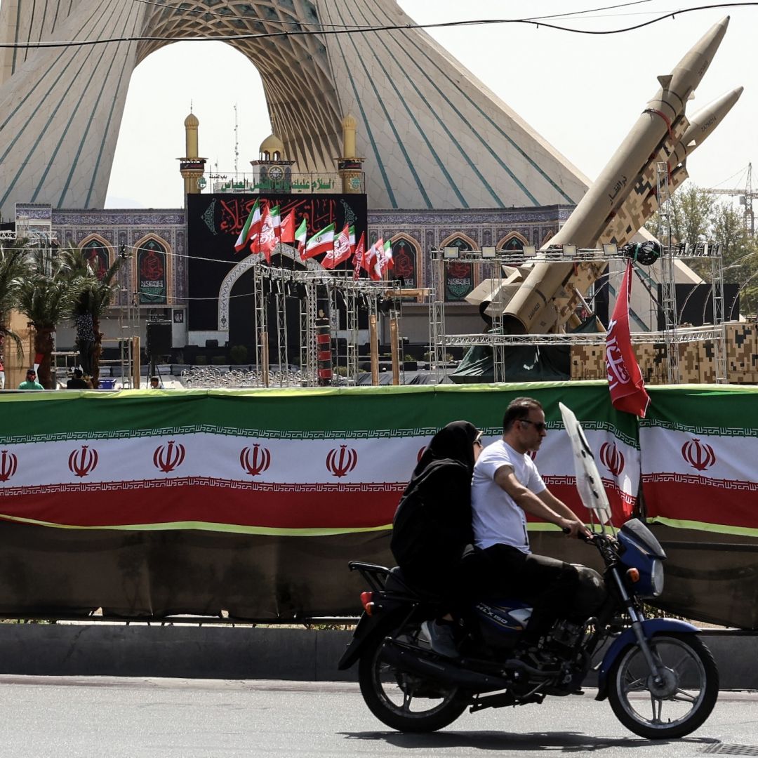 A couple rides past Iranian-made Zolfaghar missiles displayed at Azadi Square in Tehran on July 24. A couple rides past Iranian-made Zolfaghar missiles displayed at Azadi Square in Tehran on July 24.