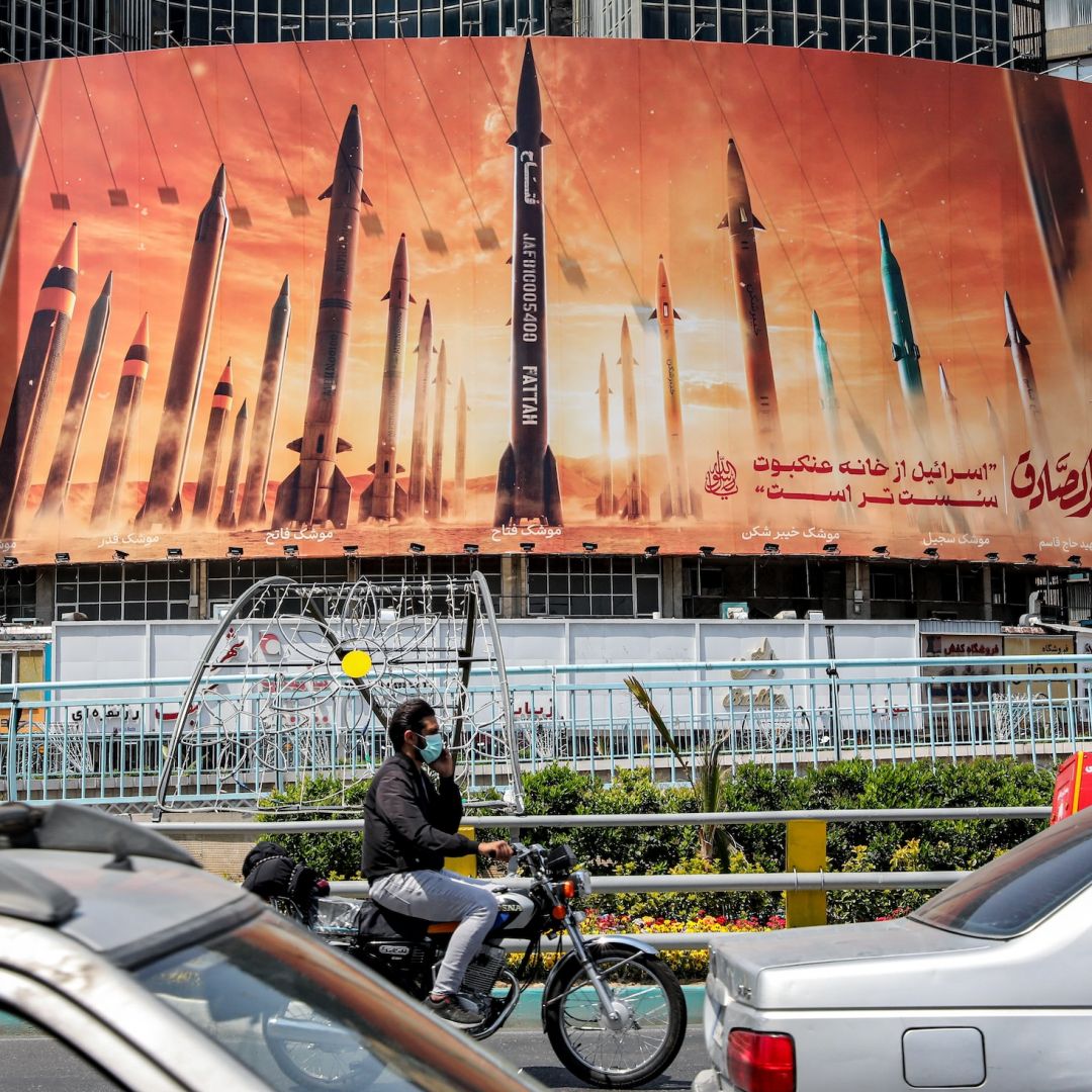 A banner depicts IRGC missile models aimed at Israel on April 16 in the Iranian capital of Tehran.