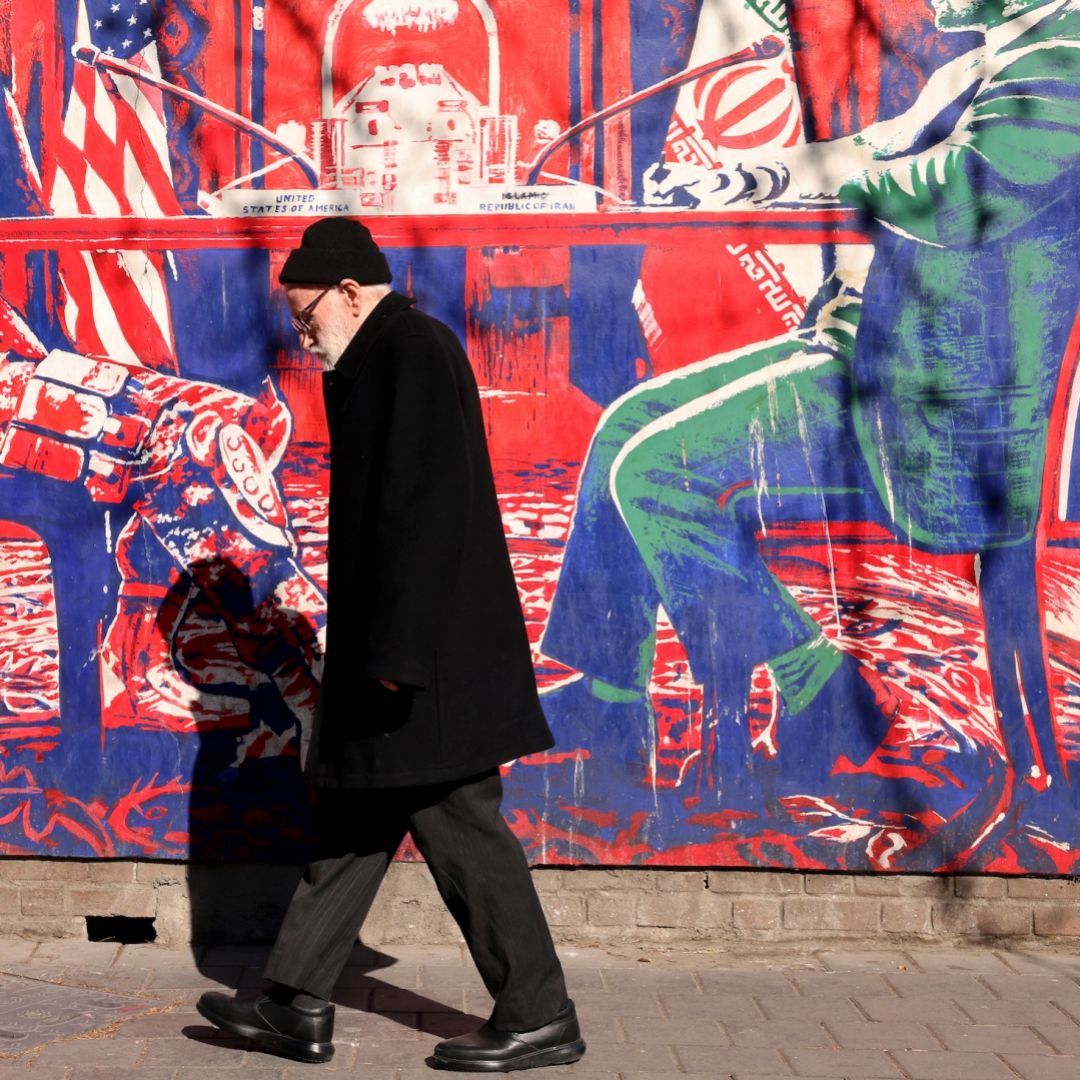 A man walks past a mural painted on the outer walls of the former U.S. embassy in Tehran, Iran, on Feb. 1, 2026.