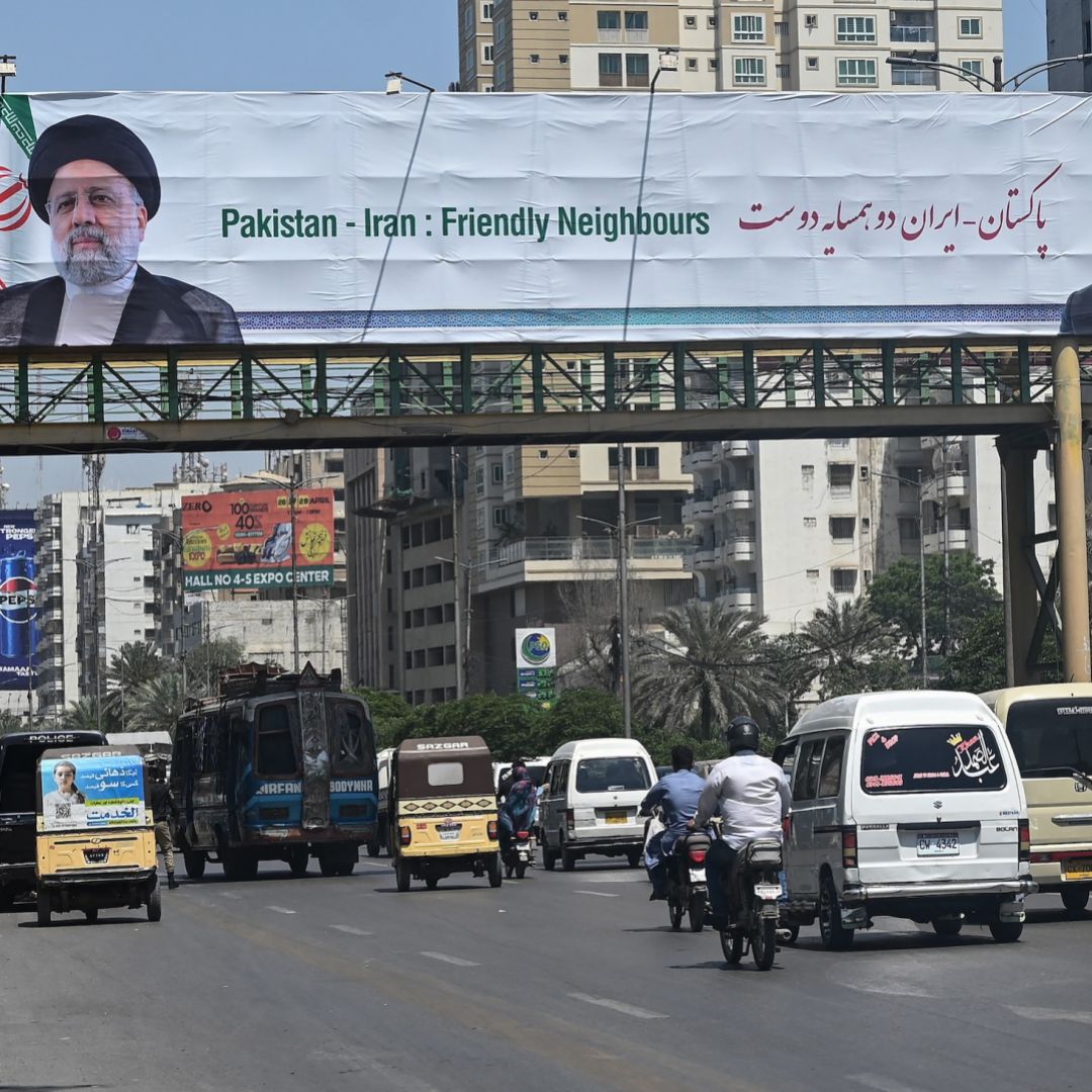 A welcoming billboard displaying an image of Iranian President Ebrahim Raisi (left) and Pakistani Prime Minister Shehbaz Sharif is seen along a street in Karachi, Pakistan, on April 22, 2024. 