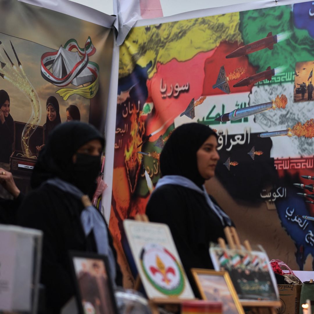 Iraqi women light candles in memory of the victims of the U.S.-Israeli attacks on Iran and Lebanon during a rally in Baghdad's Tahrir Square on April 2, 2026.