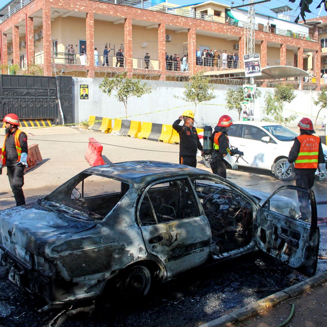 Firefighters douse a car at the suicide blast site in Islamabad, Pakistan, on Nov. 11, 2025. 