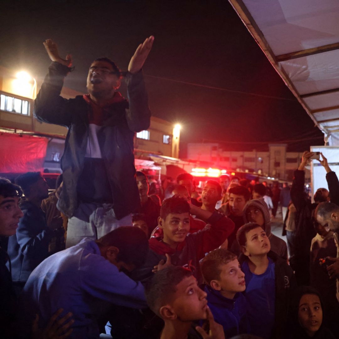 People celebrate while watching news coverage of the Israel-Hamas ceasefire in Khan Yunis in the southern Gaza Strip on Jan. 15, 2025.