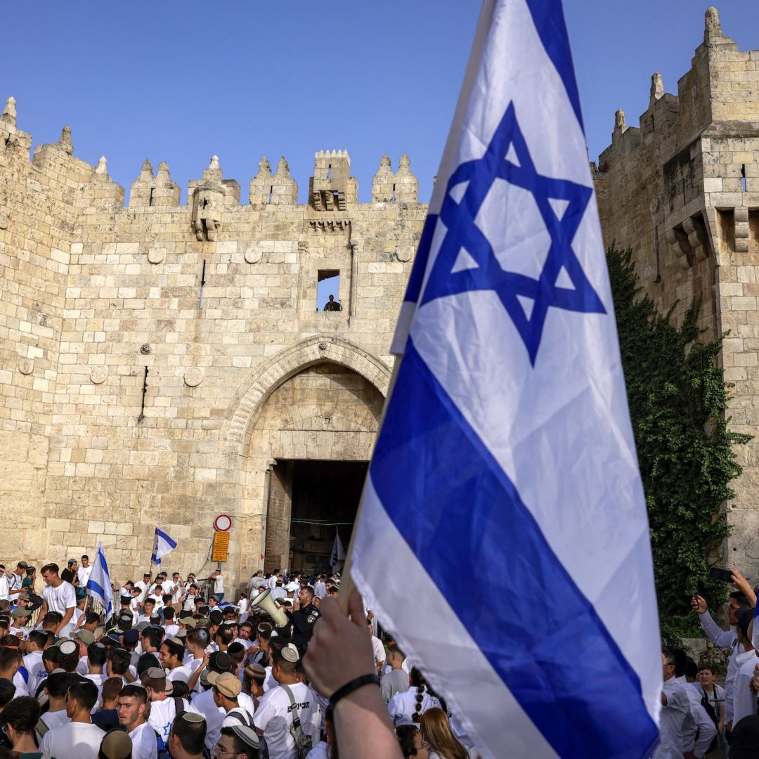 Right-wing activists gather with Israeli flags outside the Damascus Gate of the walled Old City of Jerusalem on May 26, 2025, during a flag march for Jerusalem Day, commemorating the Israeli army's 1967 capture of the city's eastern sector during the Arab-Israeli war.