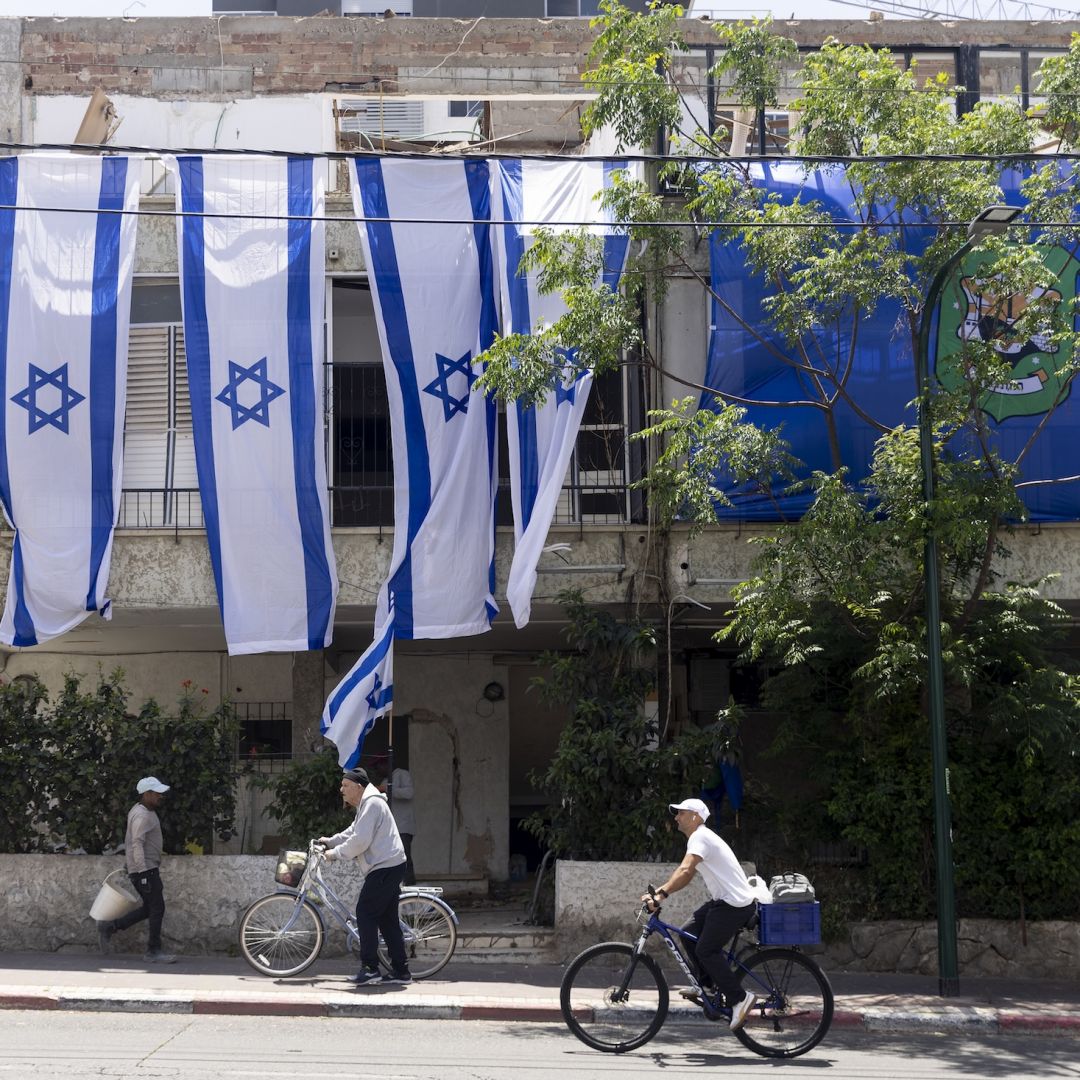 People pass by a building in Ramat Gan, Israel, that was destroyed by an Iranian ballistic missile on May 5, 2026. 