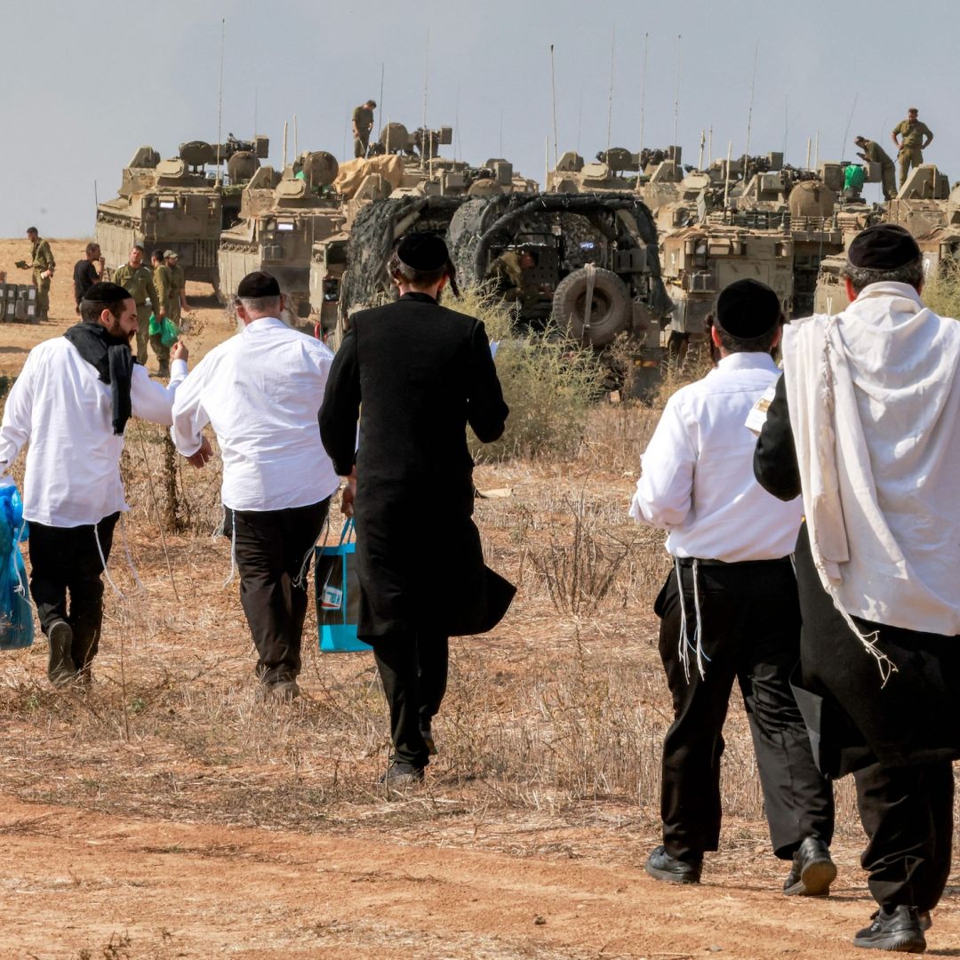 Ultra-Orthodox Jews visit Israeli army soldiers to show their support as they deploy at a position near the border with Gaza in southern Israel on Oct. 11, 2023. 