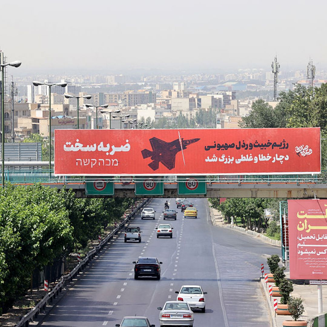 Vehicles drive along a main thoroughfare past a billboard that reads in Farsi and Hebrew: "A severe blow... The vile and villainous Zionist regime (Israel) has made a grave mistake,” in central Tehran on June 24, 2025. Vehicles drive along a main thoroughfare past a billboard that reads in Farsi and Hebrew: "A severe blow... The vile and villainous Zionist regime (Israel) has made a grave mistake,” in central Tehran on June 24, 2025.