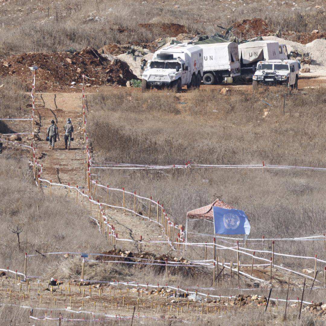 A photograph taken from the Israeli side of the border with southern Lebanon shows U.N. peacekeepers clearing landmines on Nov. 19, 2025. 