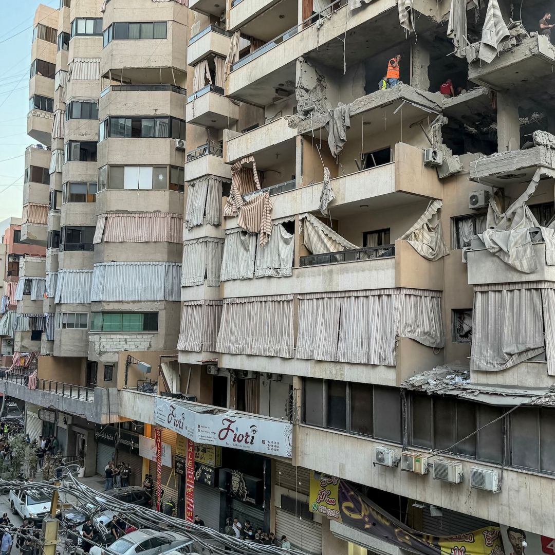 Workers clean the rubble from the site of a Nov. 23 Israeli airstrike targeting a residential building in the southern Haret Hreik neighborhood of Beirut.