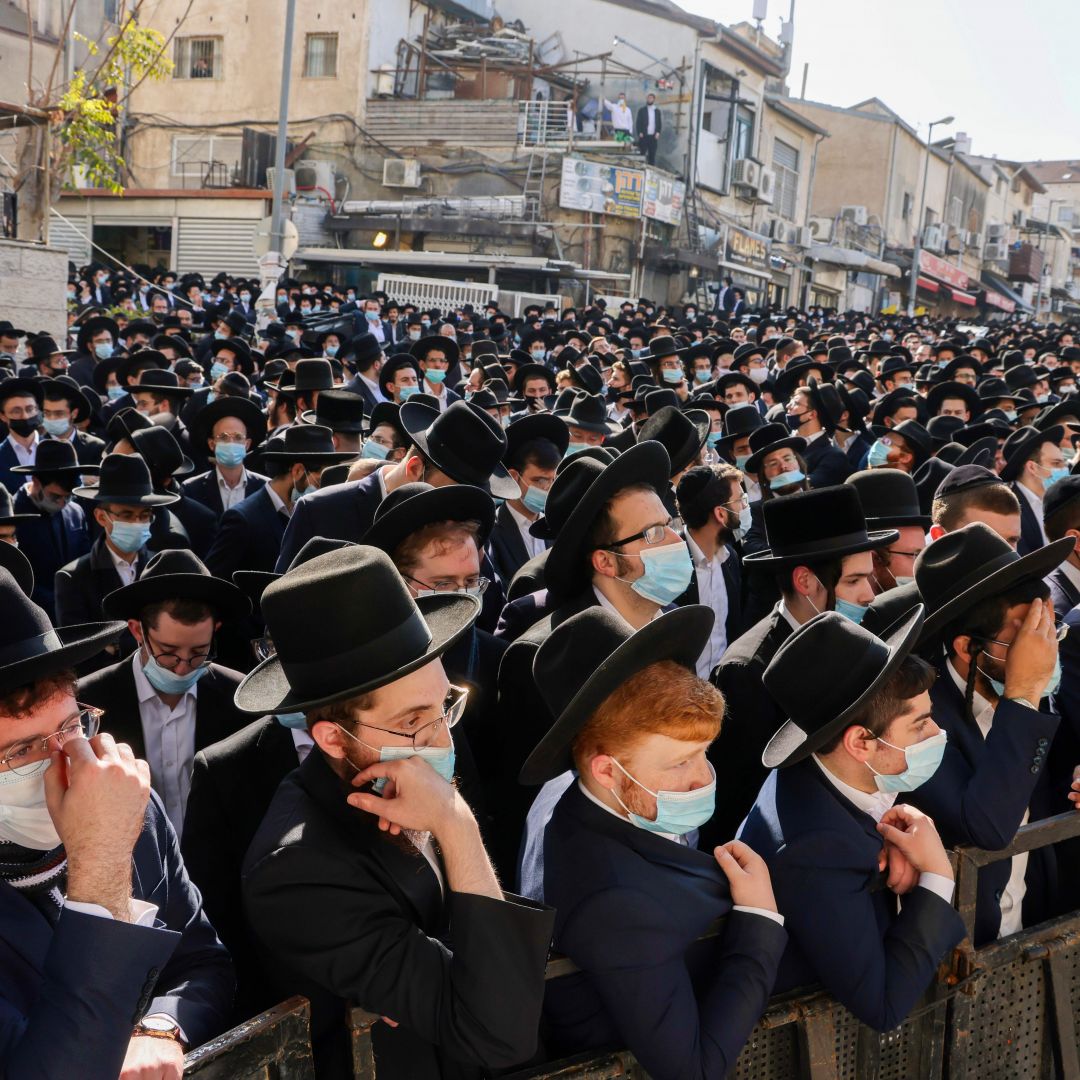 Ultra-Orthodox Jewish men attend the funeral of Rabbi Aharon David Hadash, the spiritual leader of the Mir Yeshiva, in Jerusalem's ultra-Orthodox neighborhood of Beit Yisrael on Dec. 3, 2020.