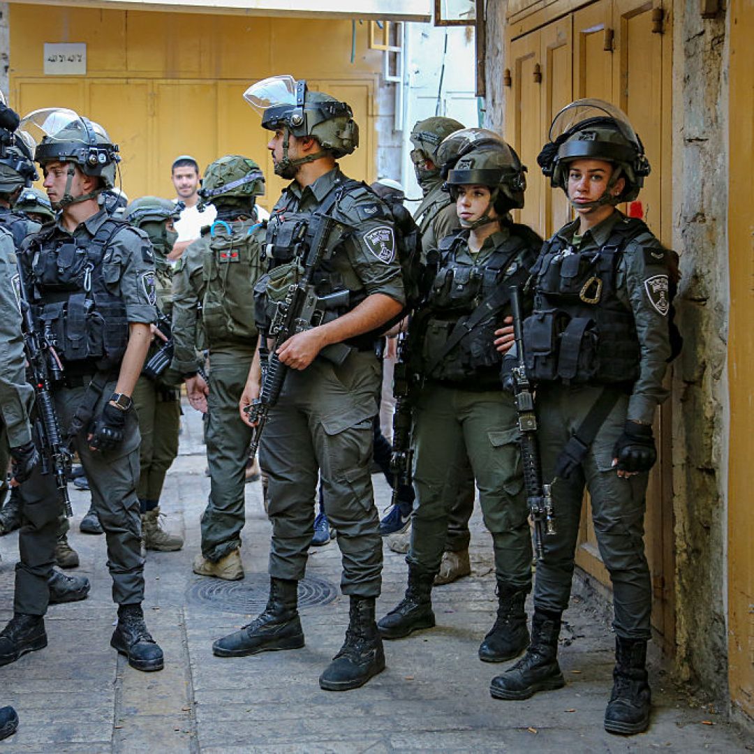 A group of armed Israeli soldiers stands in a narrow alley of the Old City of Hebron, West Bank, on May 31, 2025. A group of armed Israeli soldiers stands in a narrow alley of the Old City of Hebron, West Bank, on May 31, 2025.