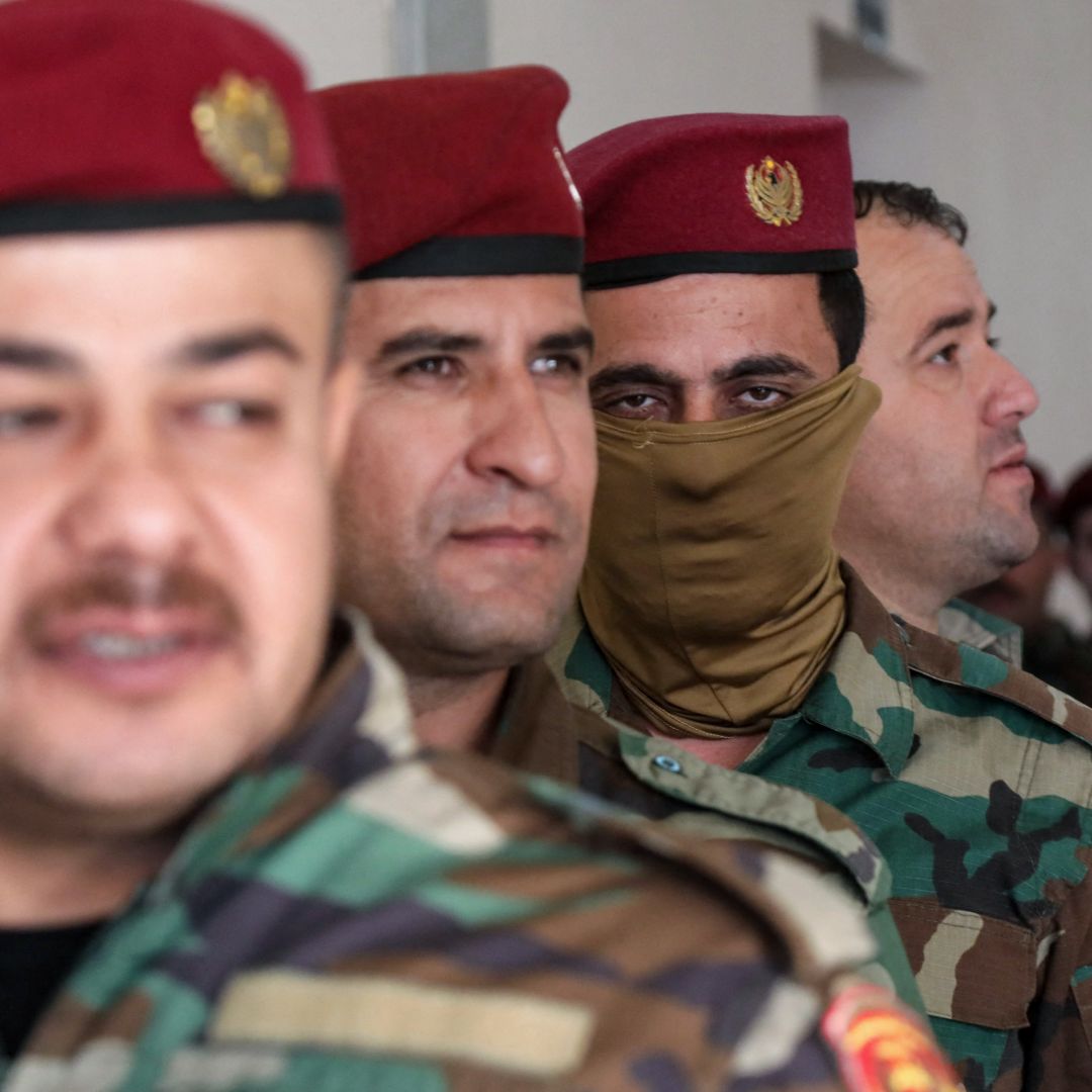 Members of the Kurdish peshmerga security forces queue at a polling station to vote ahead of the Oct. 20 parliamentary election in Arbil, the capital of Iraq's autonomous Kurdish region, on Oct. 18, 2024. 