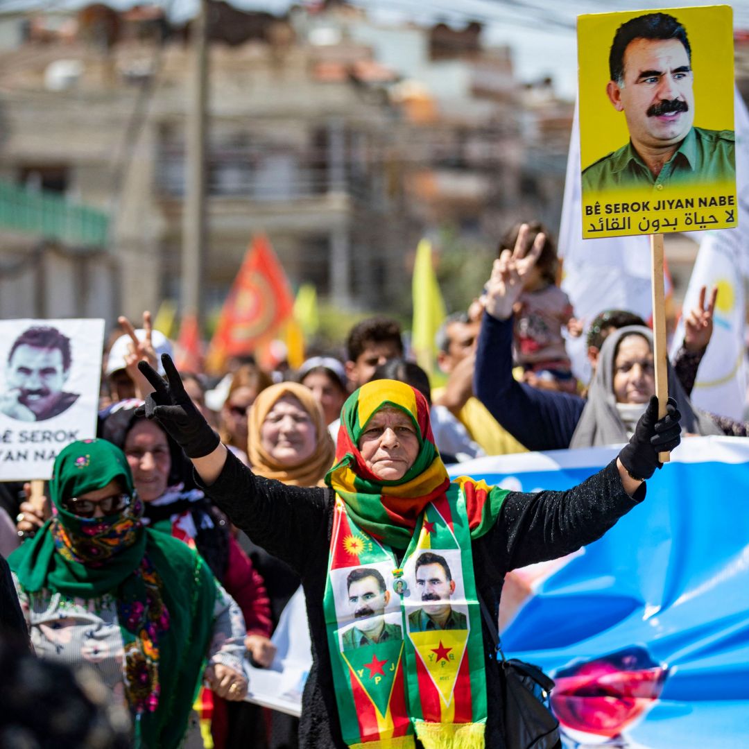 Syrian Kurds gather in the northeastern city of Qamishli on May 10, 2023, to show their support for the Turkish opposition ahead of Turkey's election. Images of Abdullah Ocalan, the leader of the Kurdistan Worker's Party (PKK), are seen on some demonstrators' placards and clothing. Syrian Kurds gather in the northeastern city of Qamishli on May 10, 2023, to show their support for the Turkish opposition ahead of Turkey's election. Images of Abdullah Ocalan, the leader of the Kurdistan Worker's Party (PKK), are seen on some demonstrators' placards and clothing.