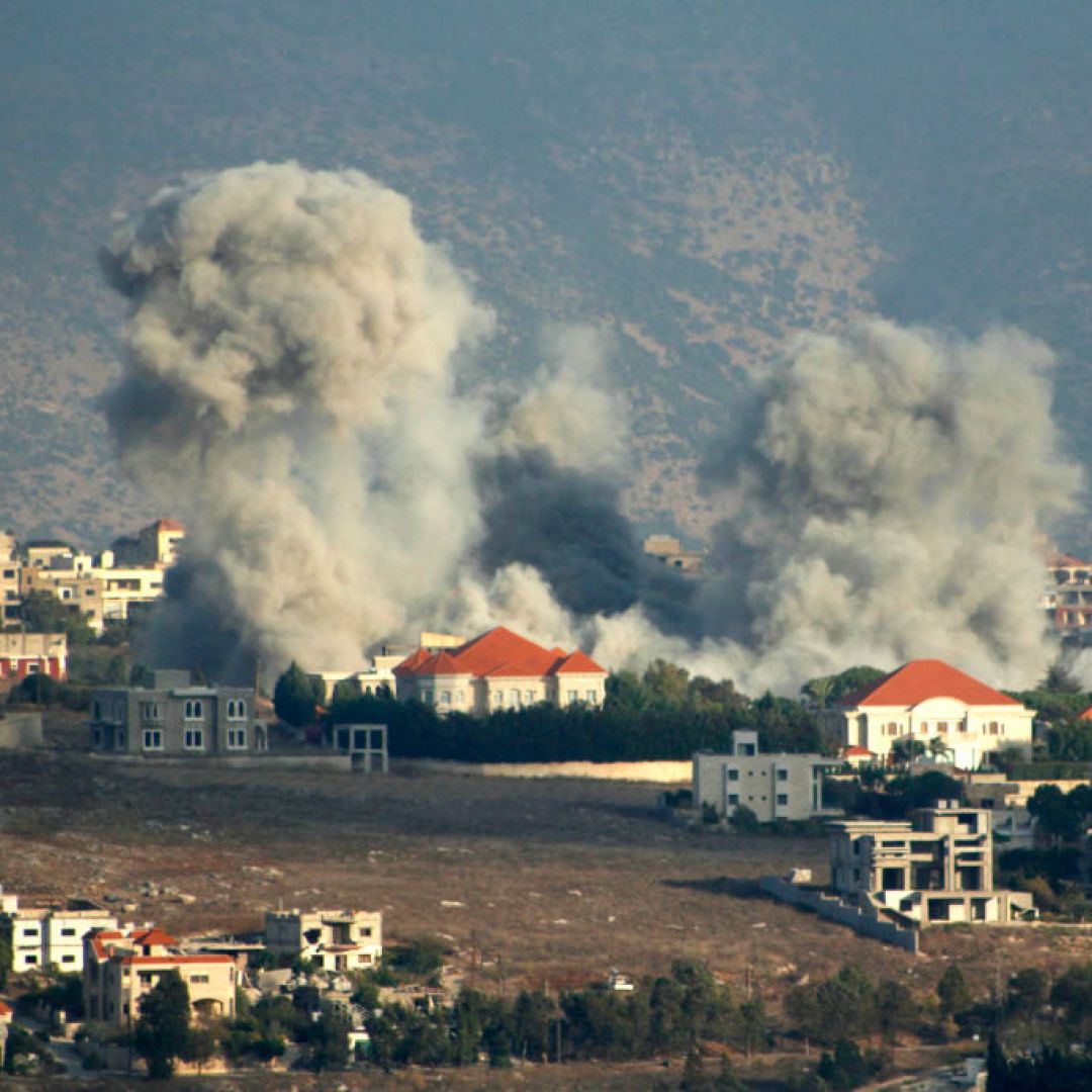 A plume of smoke billows following an Israeli air strike above a border town in southern Lebanon on Oct. 7, 2024. 