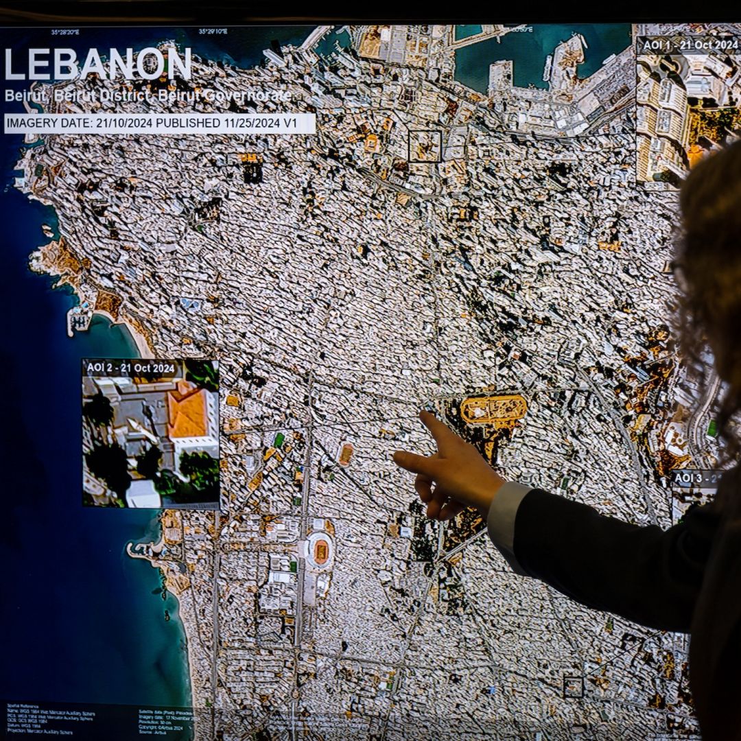 U.N. Satellite Center cultural heritage analyst Michelle de Gruchy gestures next to a map of Beirut, Lebanon, during a press conference in Geneva, Switzerland, on monitoring damage to cultural heritage in Lebanon and Gaza on Nov. 25, 2024.