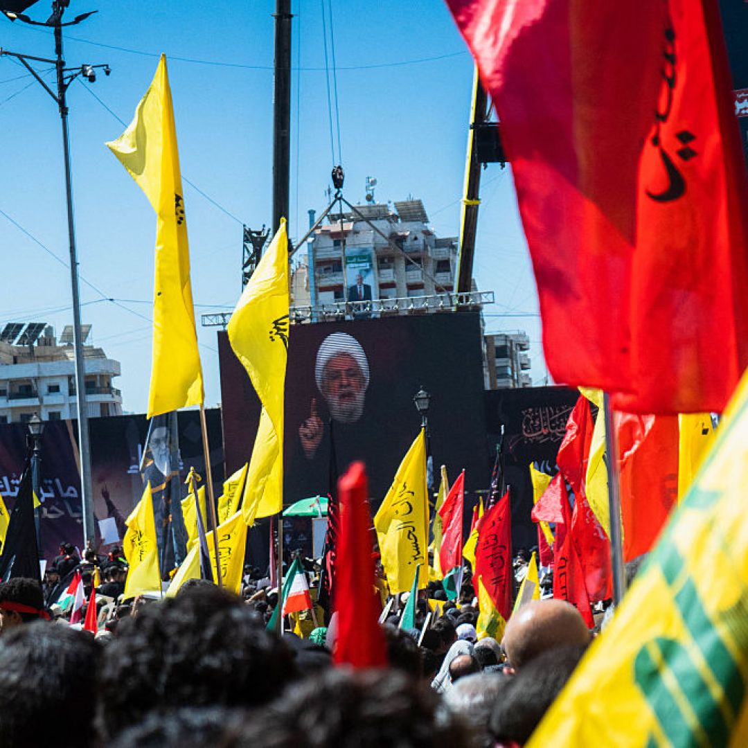 Hezbollah leader Naim Kassem speaks from a stage surrounded by flags in the southern suburbs of Beirut, Lebanon, on July 6, 2025. Hezbollah leader Naim Kassem speaks from a stage surrounded by flags in the southern suburbs of Beirut, Lebanon, on July 6, 2025.