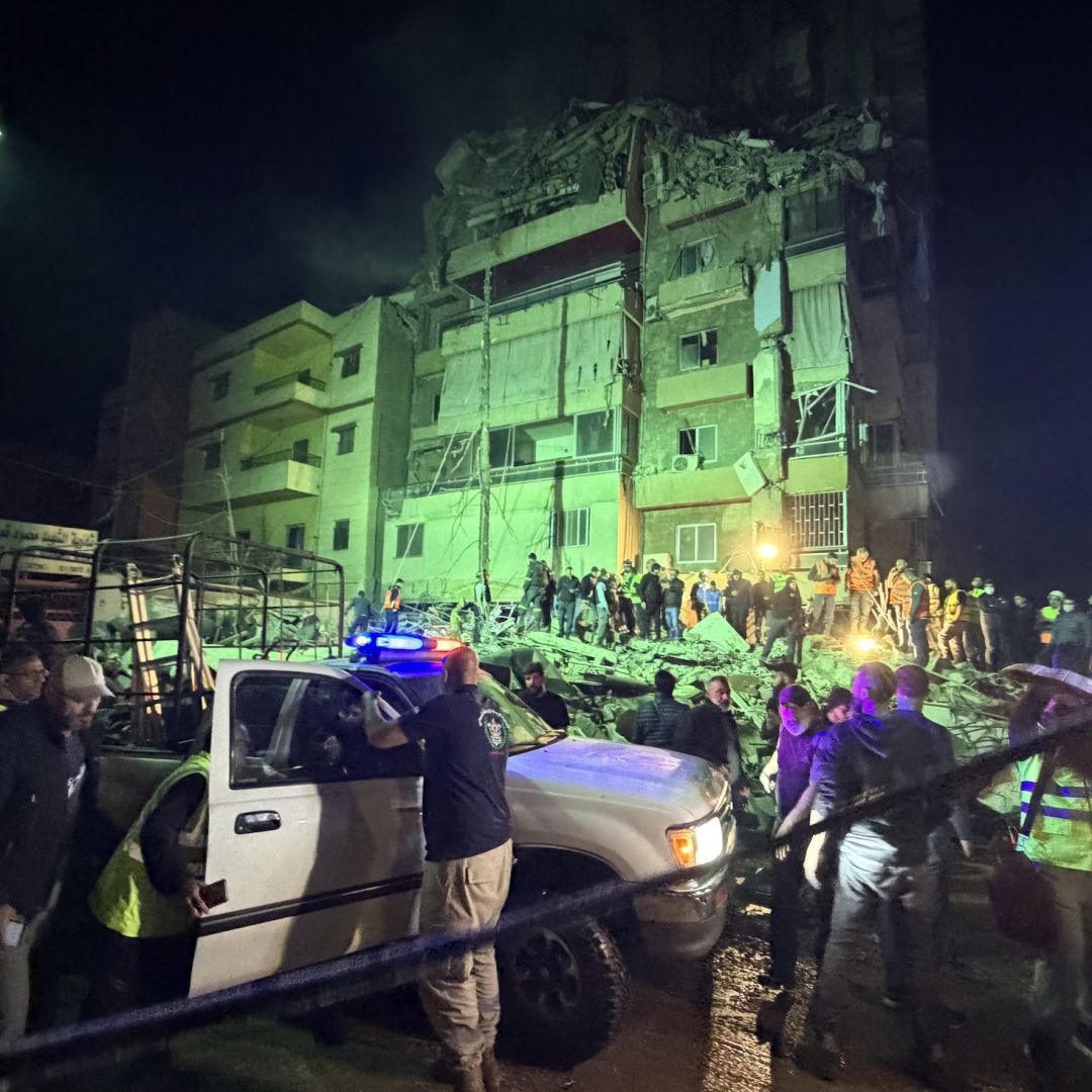 People gather at the site of an Israeli airstrike that targeted Beirut's southern suburbs on May 6, 2026.