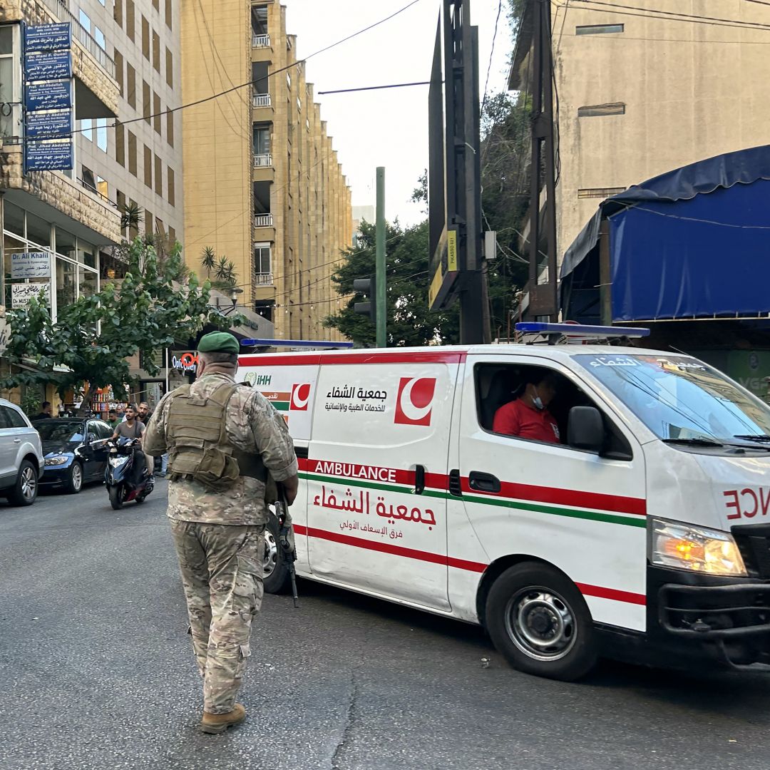 Lebanese soldiers stand guard as an ambulance rushes wounded people to a hospital in Beirut on Sept. 17, 2024, after explosions hit locations in several Hezbollah strongholds around Lebanon amid ongoing cross-border tensions between Israel and Hezbollah fighters.