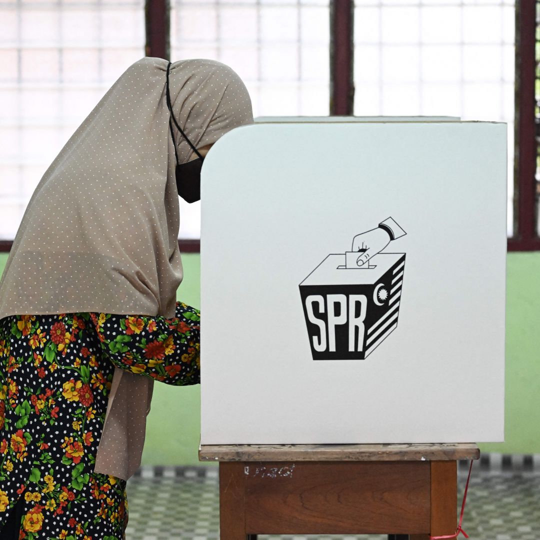 A woman casts a vote at a polling station during Malaysia's general election on Nov. 19, 2022. 