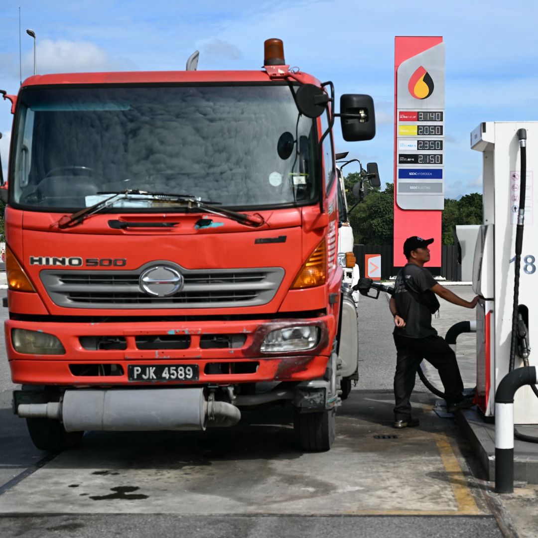 A man fills up his truck at a Petroleum Sarawak Berhad (Petros) station in Kuching, Malaysia, on June 20, 2025.