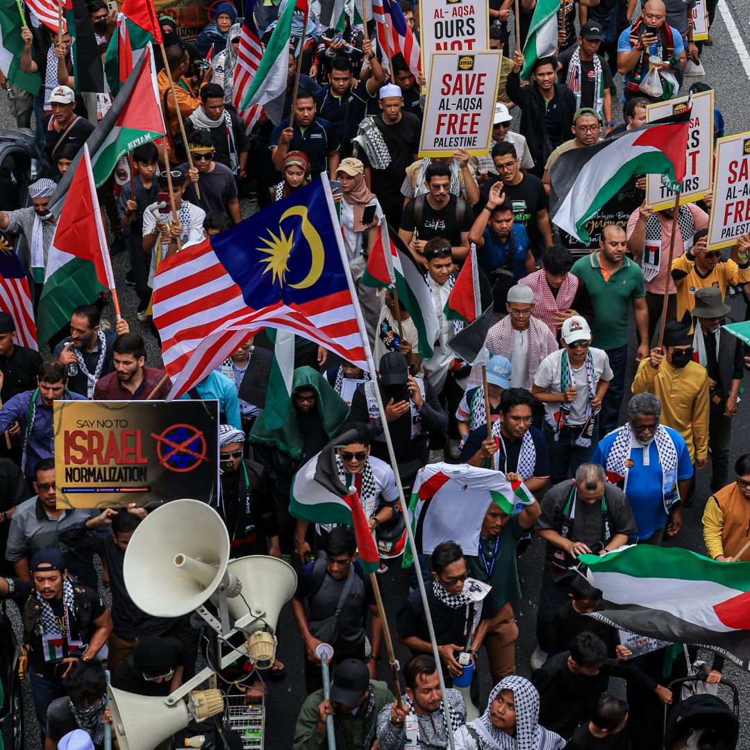 Malaysian Muslim activists and Palestinian nationals gather to express solidarity with the people of Palestine as they march toward the U.S. Embassy in Kuala Lumpur, Malaysia, on Oct. 13, 2023. 