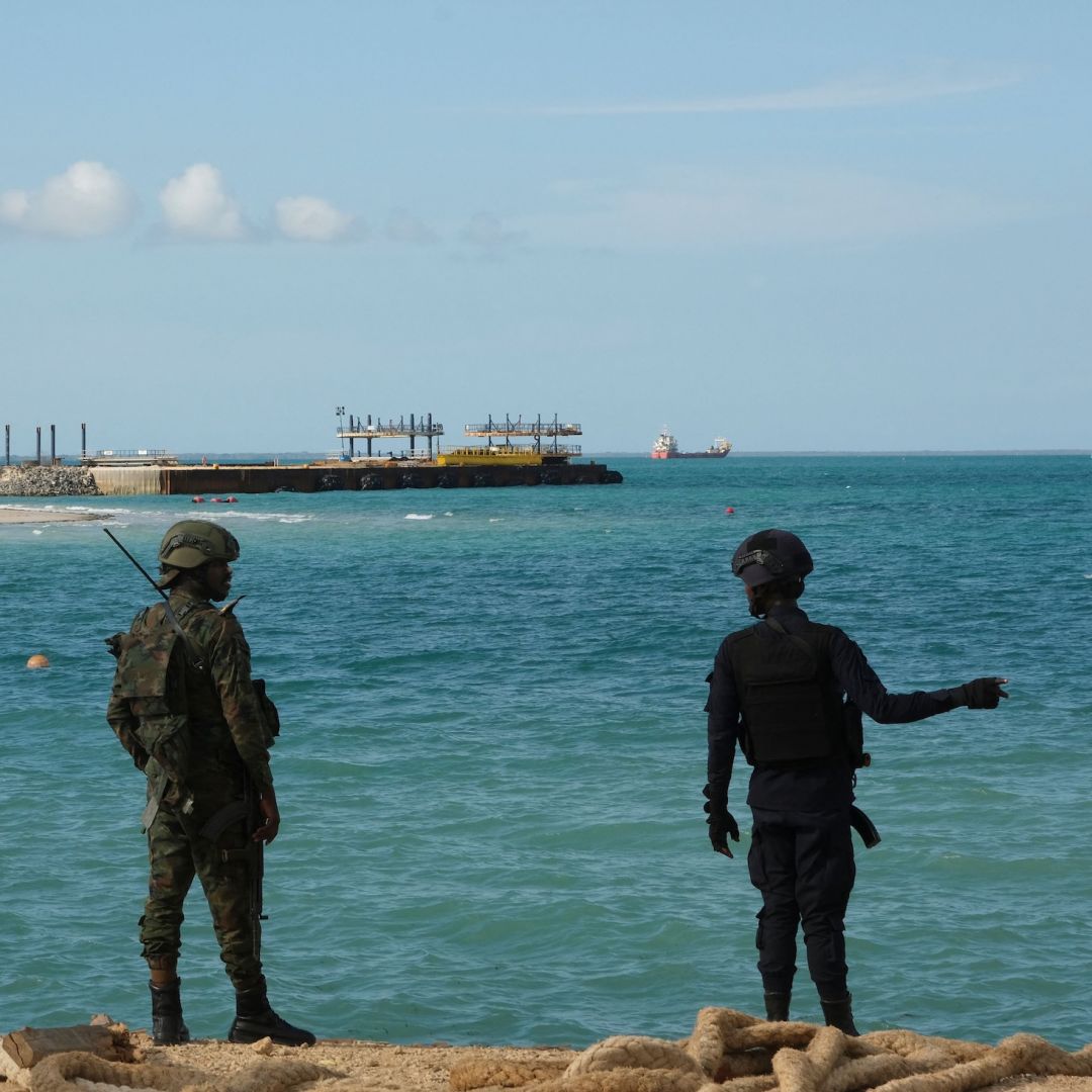 A Rwandan policeman (R) and a Rwandan soldier (L) guard TotalEnergies' Mozambique LNG project in Cabo Delgado province, Mozambique, on Sept. 29, 2022.