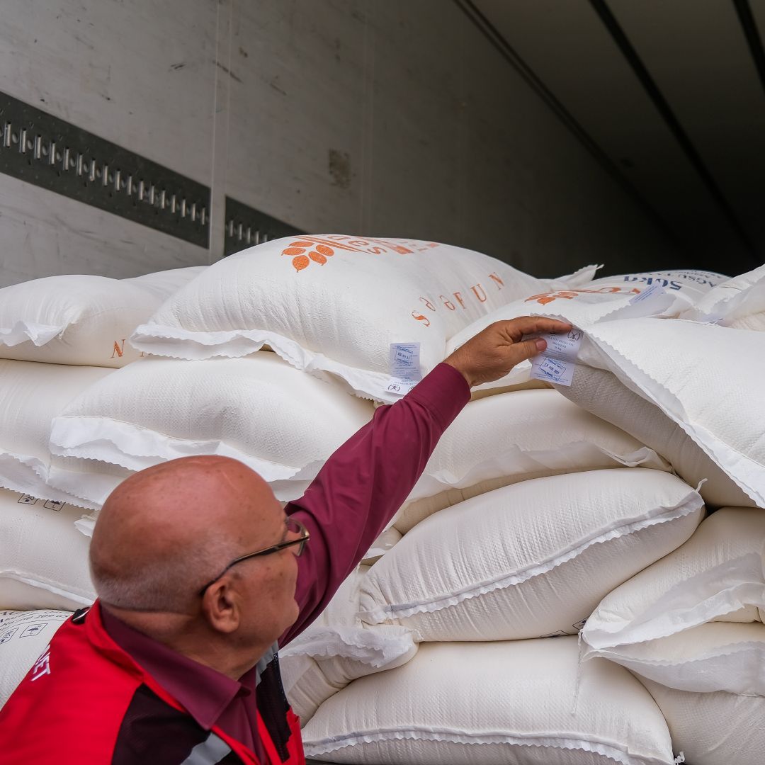 A member of the Red Crescent shows bags of flour on Aug. 30, 2023, in Aghdam, Azerbaijan. 