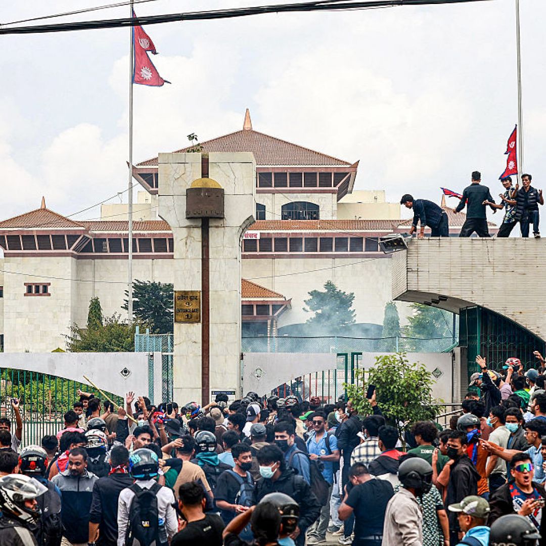 Demonstrators carrying Nepal's national flag stage a protest outside the parliament building in Kathmandu on Sept. 8, 2025, against social media prohibitions and government corruption. Demonstrators carrying Nepal's national flag stage a protest outside the parliament building in Kathmandu on Sept. 8, 2025, against social media prohibitions and government corruption.