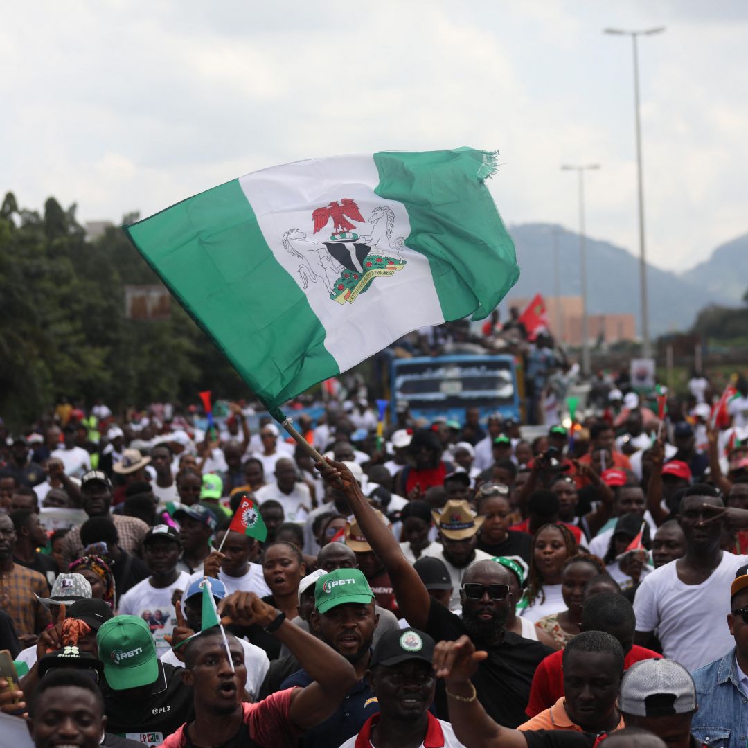 The Nigerian flag is waved above a crowd at a political rally for Labor Party candidate Peter Obi in Abuja, Nigeria, on Sept. 24, 2022. The Nigerian flag is waved above a crowd at a political rally for Labor Party candidate Peter Obi in Abuja, Nigeria, on Sept. 24, 2022.