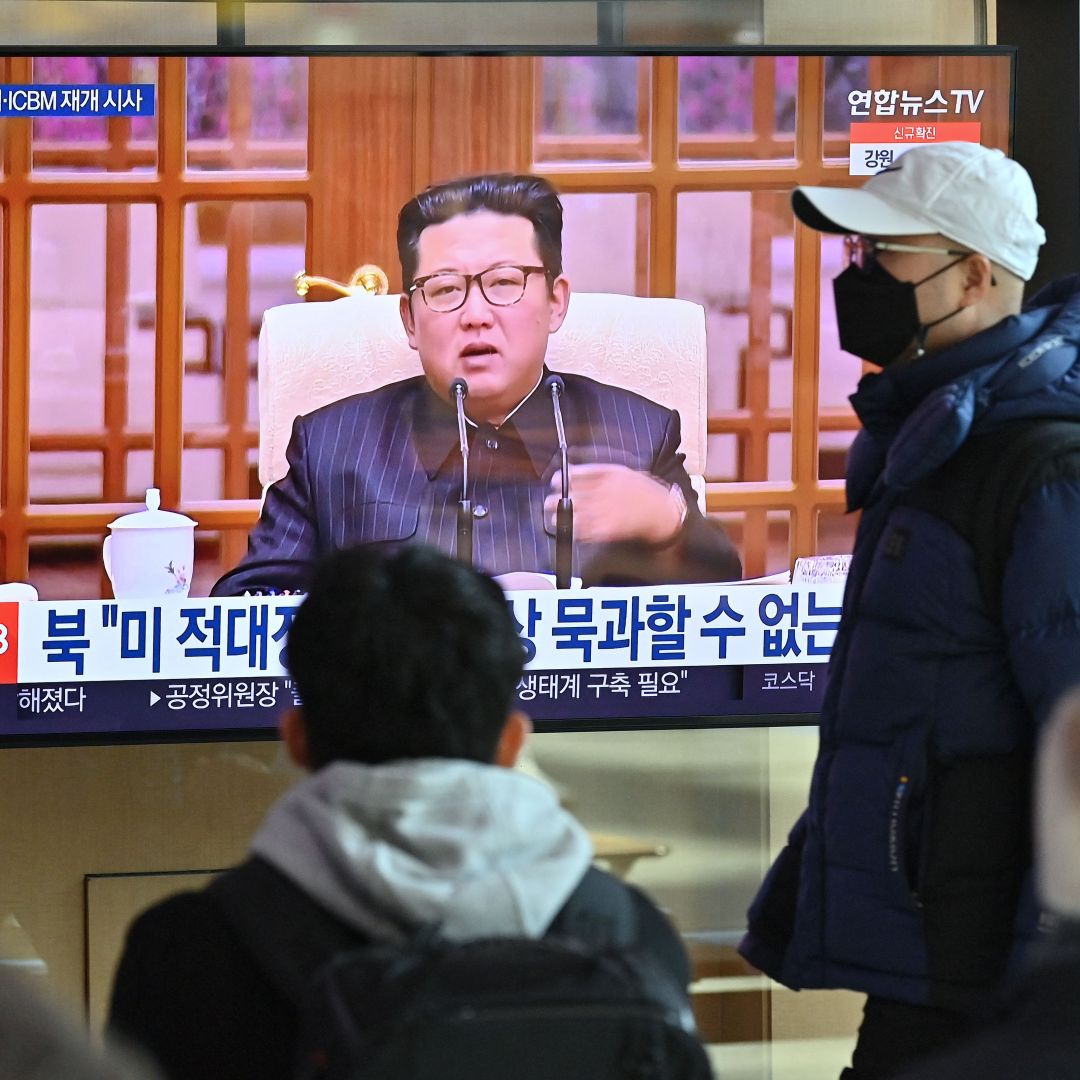 People watch a television screen showing a news broadcast with file footage of North Korean leader Kim Jong Un, at a railway station in Seoul, South Korea, on Jan. 20, 2022, after North Korea hinted it could resume nuclear and long-range weapons tests. 