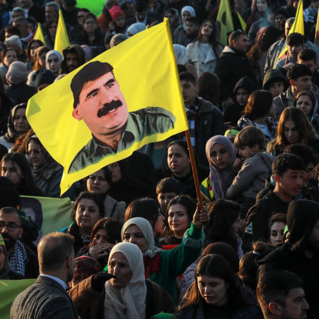 A Syrian Kurdish woman waves a flag bearing a picture of the founder of the Kurdistan Workers' Party (PKK), Abdullah Ocalan, as people gather in the Kurdish-majority city of Qamishli in northeastern Syria to listen to a message from the jailed leader on Feb. 27, 2025. A Syrian Kurdish woman waves a flag bearing a picture of the founder of the Kurdistan Workers' Party (PKK), Abdullah Ocalan, as people gather in the Kurdish-majority city of Qamishli in northeastern Syria to listen to a message from the jailed leader on Feb. 27, 2025.