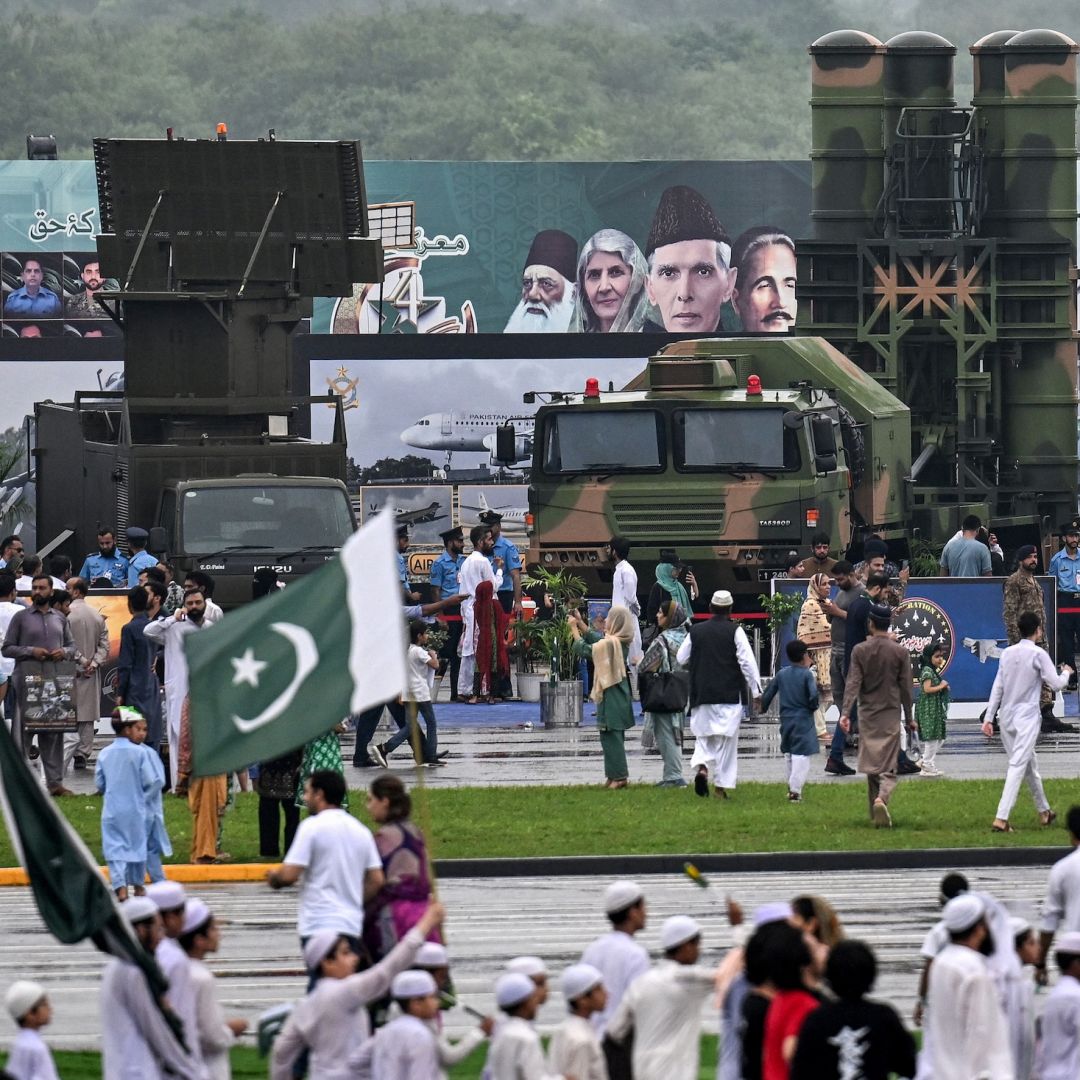 People gather around an army air defense system on display at a military exhibition in Islamabad, Pakistan, on Aug. 14, 2025.